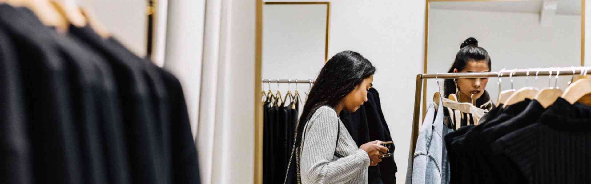 Two women shopping in a clothing store.