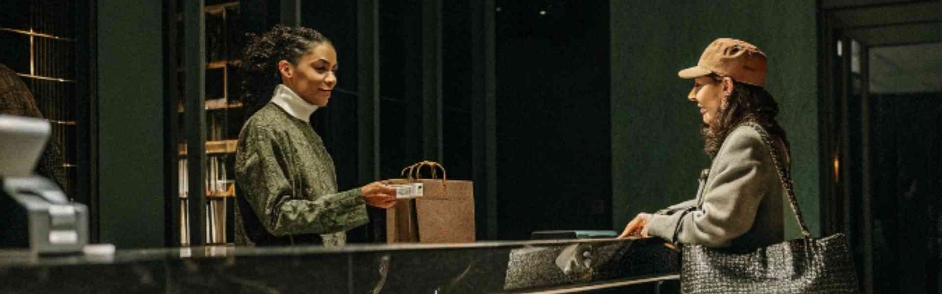 A customer making a payment at a stylish boutique counter.