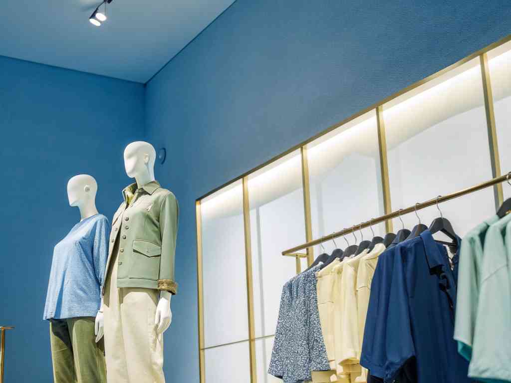 Mannequins dressed in stylish outfits in a modern clothing store.