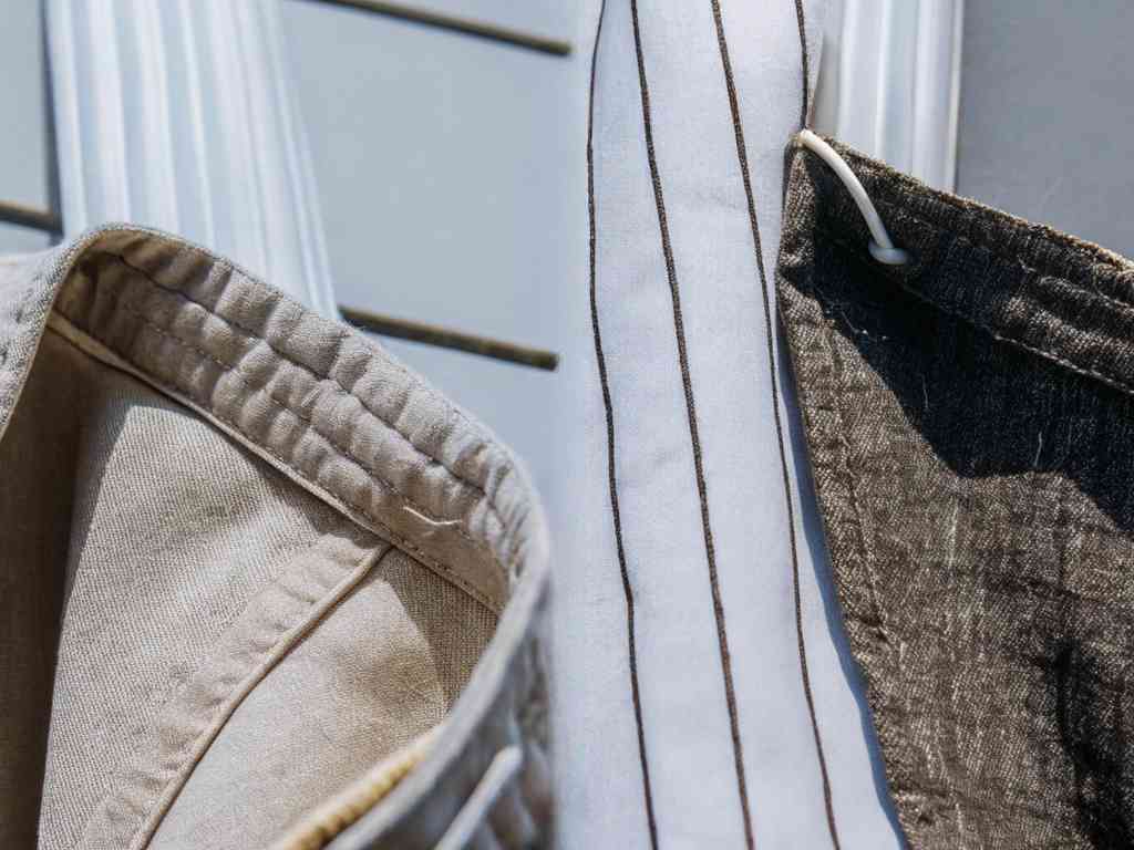 Close-up of linen and cotton garments drying in sunlight.