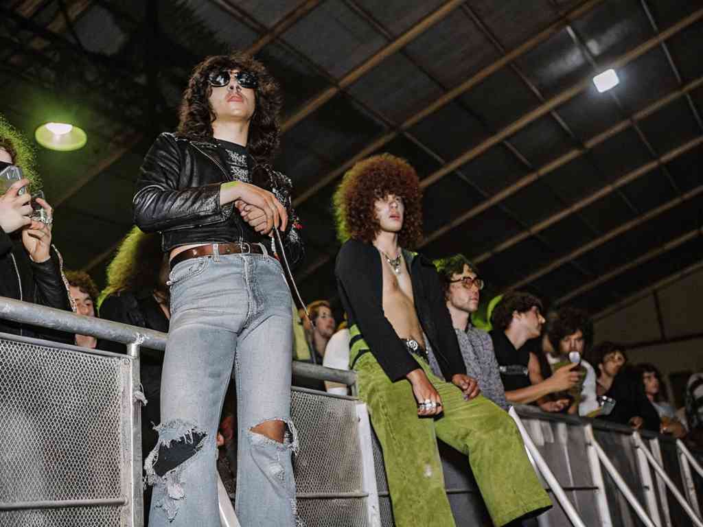 Stylish concertgoers in vintage outfits watching a live music event