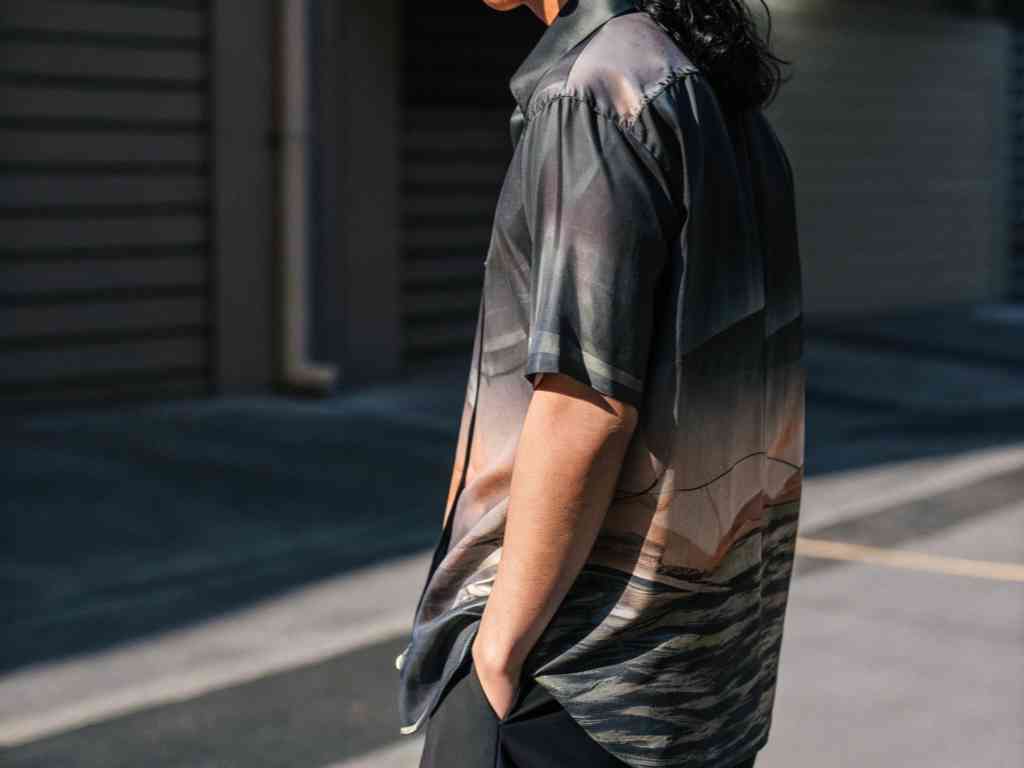 Person wearing printed shirt with scenic landscape design