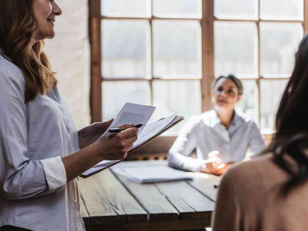 Woman holding documents leading team discussion.