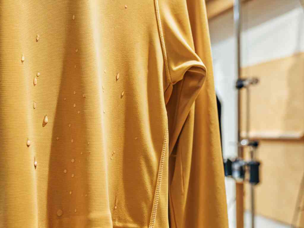 Water droplets on yellow waterproof fabric