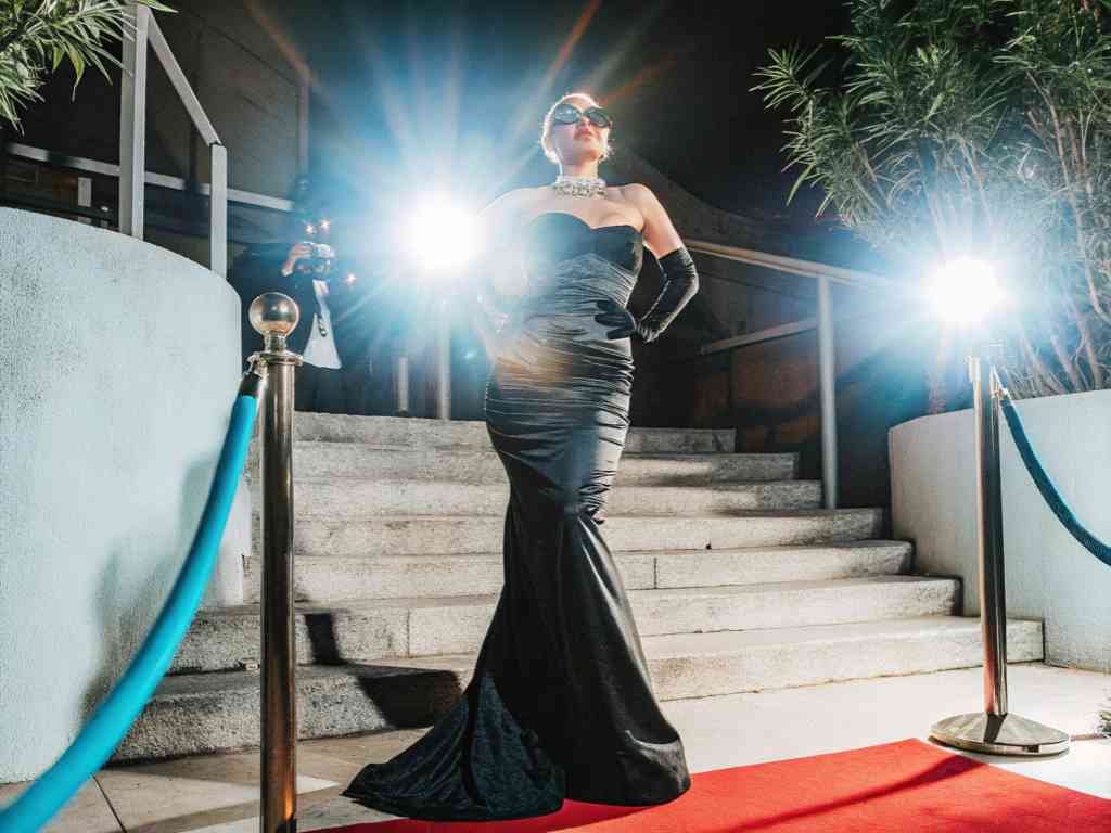 Woman in black evening gown on red carpet