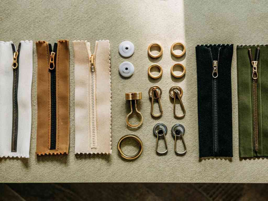 Various zipper samples and metal accessories on table