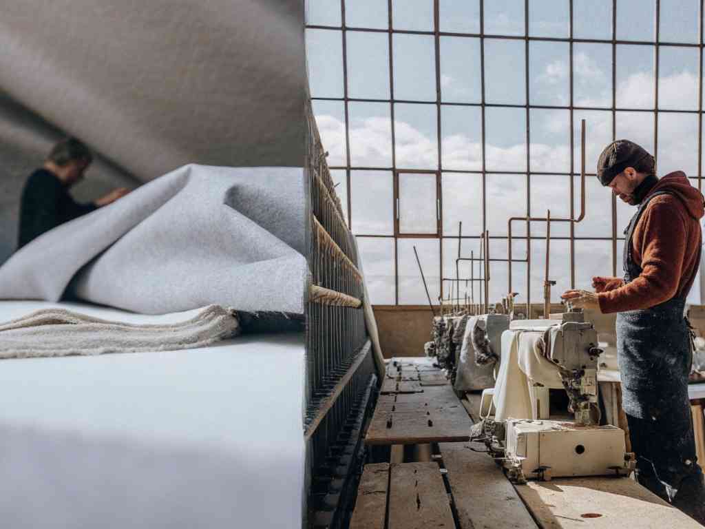 Fabric and sewing machine in a well-lit workshop.