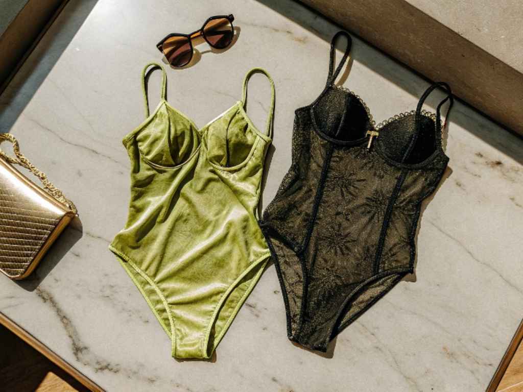 Green velvet and black mesh bodysuits styled with gold purse and sunglasses