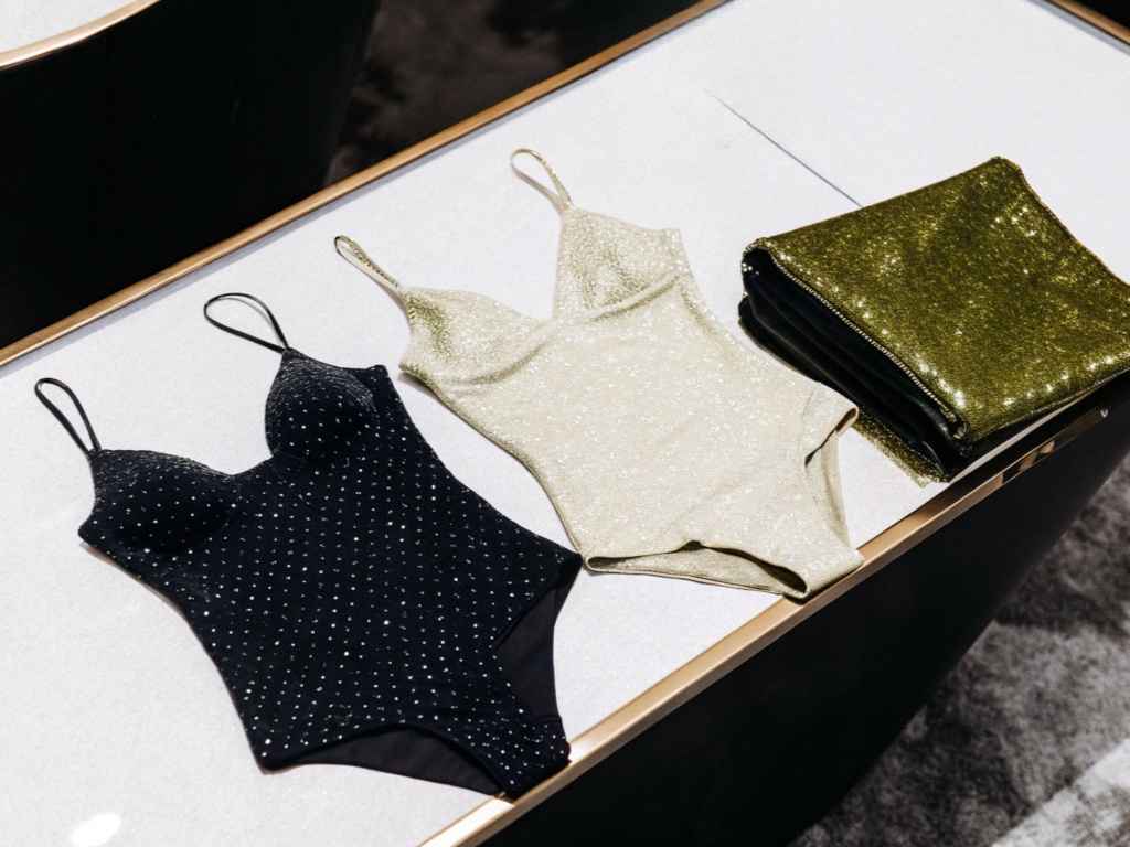 Black and gold glitter bodysuits with folded shimmer fabric