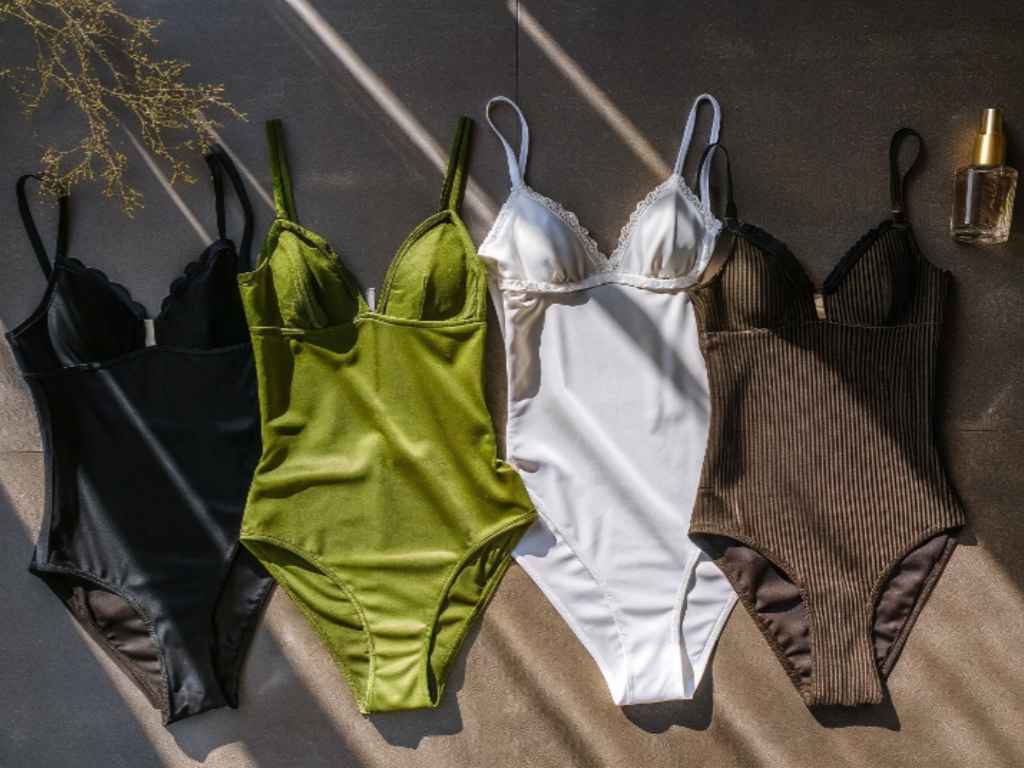Four bodysuit lingerie pieces in black, green, white, and brown