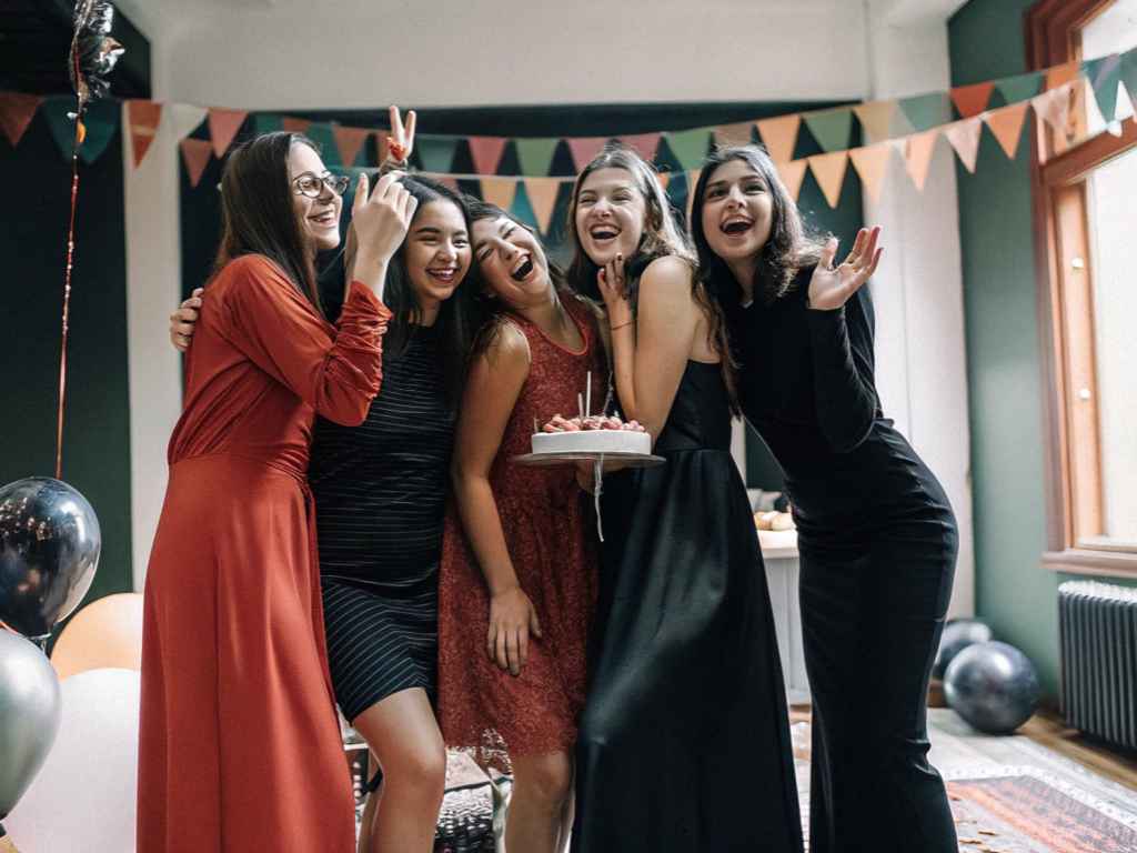 Group of girls celebrating birthday in party dresses