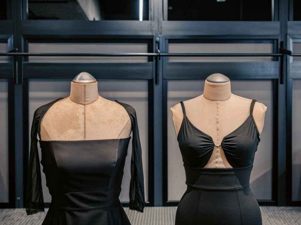 Two mannequins with black dresses in fashion studio