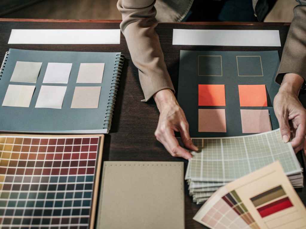 Designer organizing fabric swatches and color palettes.