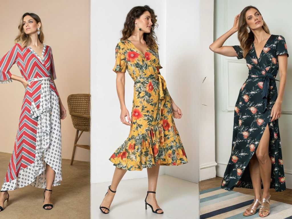 Three women modeling colorful floral and geometric wrap dresses.
