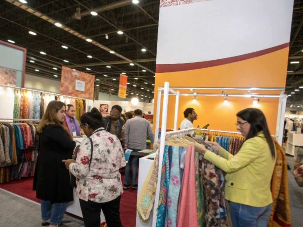People browsing fabric at Alibaba Global Sourcing Expo booth.